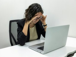 a woman sitting in front of a laptop computer