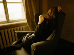 woman sitting on wing chair