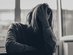 grayscale photography of person covering face
